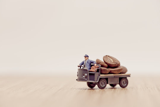 Miniature toy truck loaded with brown coffee beans