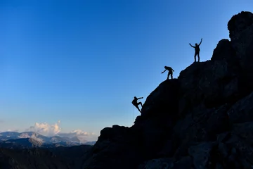 Fototapeten challenging rock climbing and successful team spirit © emerald_media