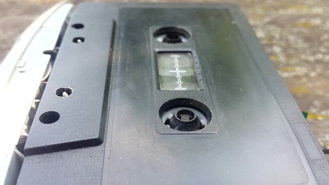 The Vintage Black Audio Cassette in the Tape Recorder Rotates