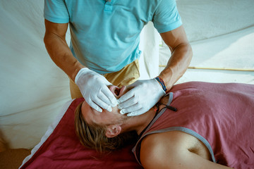Reception at the doctor. Alternative medicine. Osteopathy. Massage. Place for advertising. The manual therapist checks the patient's jaw.