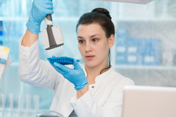 Young woman with genetic research in the laboratory research of cancer diseases