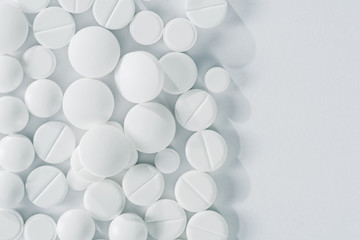 White pills and tablets isolated on white, closeup, top view