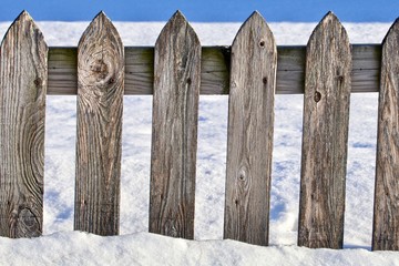 Worn Gray Picket Fence in the Snow