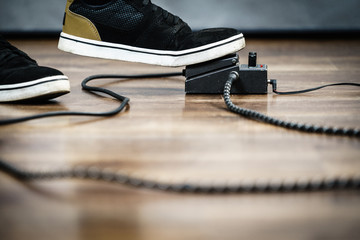 Man using guitar effects pedal
