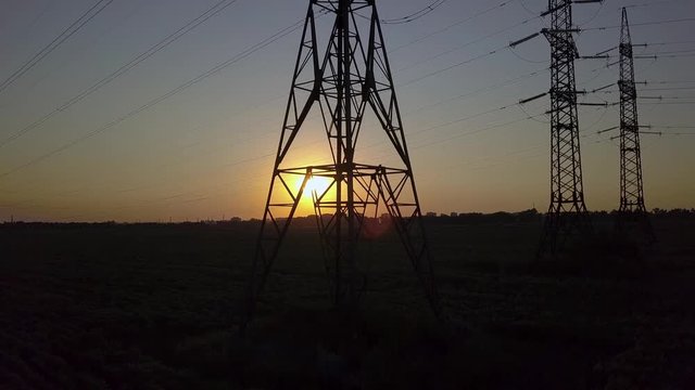 Aerial View of Sunset and High-voltage power pylon. Fuel and power generation. 4K