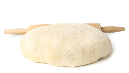 Dough and wooden rolling pin on a white background.