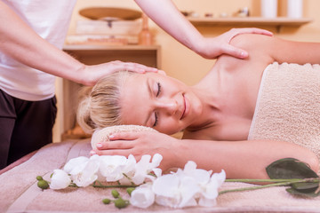 Obraz na płótnie Canvas Girl having massage in spa salon