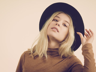 Woman wearing suede and black hat