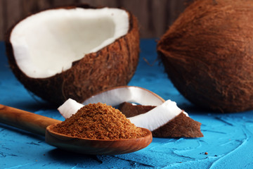 scoop of brown sugar with coconut on blue background