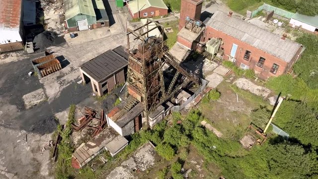 Aerial drone view of an abandoned, disused coal mine and machinery (Tower Colliery, Wales)