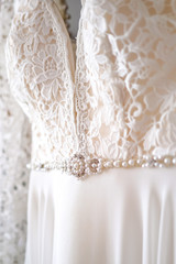 Beautiful wedding dress with lace and pearls. The concept of selling a wedding dress. close-up
