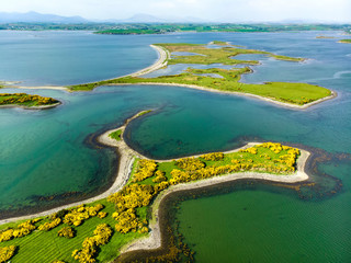 Vivid emerald-green waters and small islands near Westport town along the Wild Atlantic Way, Ireland.