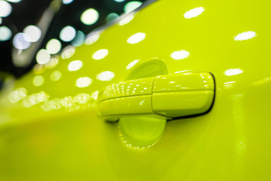 The Modern Door Handle Of A Green Car