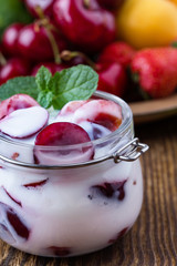 Healthy breakfast with sweet cherry yogurt and fresh  summer fruits
