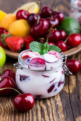 Healthy breakfast with sweet cherry yogurt and fresh  summer fruits