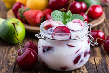Healthy breakfast with sweet cherry yogurt and fresh  summer fruits