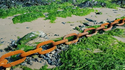 Rusty chain on beach