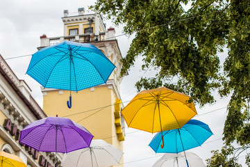 Obraz na płótnie Canvas colorful white yellow pink purple and blue umbrellas decoration on urban street environment space outdoor concept