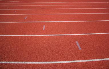 Fototapeta premium soft focus empty red running road track background texture concept with marking of white line and space for copy or text