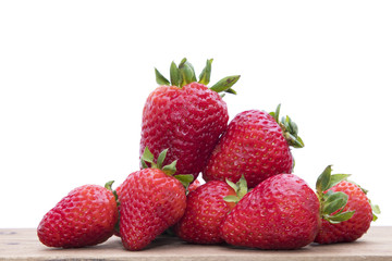 Fototapeta na wymiar isolated strawberries on a background in wood