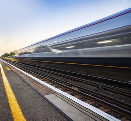 Express trains passing through a UK station at speed