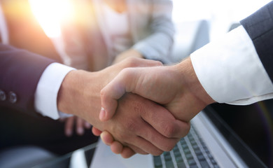 Two confidence businessman shaking hands close-up