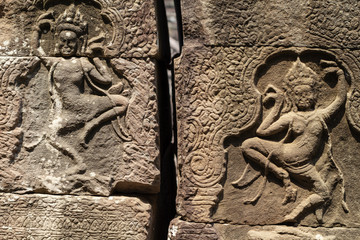 Ancient stone bas-relief of Banteay Kdei temple, Angkor Wat, Cambodia. Ancient bas-relief with apsara dance.