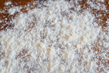 Top side view on white flour on rustic wooden table background, closeup of healthy cooking copyspace surface at home, restaurant, fabric plant