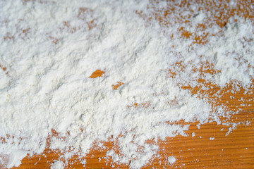 Fototapeta premium Top side view on white flour on rustic wooden table background, closeup of healthy cooking copyspace surface at home, restaurant, fabric plant