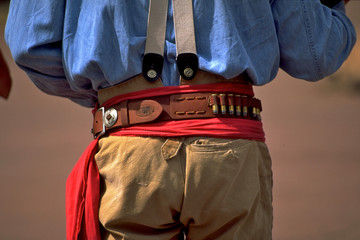 Gun fighter with gun belt and red sash from behind, Calico Ghost Town, Yermo, California 