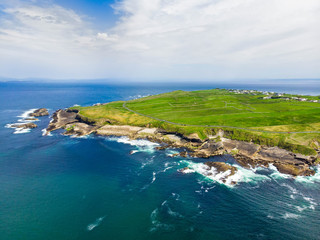 Spectacular aerial view of Mullaghmore Head with huge waves rolling ashore. Picturesque scenery with magnificent Classiebawn Castle.