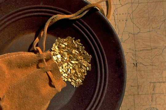 Gold Pouch, Gold Nuggets, Gold Pan, and Topographic Map.  A Gold Rush Vignette from bygone era 