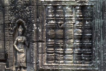 Ancient stone bas-relief of Banteay Kdei temple, Angkor Wat, Cambodia. Ancient temple bas-relief with devata.