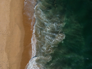 Breaking waves and sandy waters