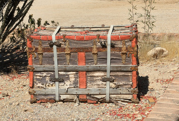 Fototapeta na wymiar Old wooden trunk sitting on gravel