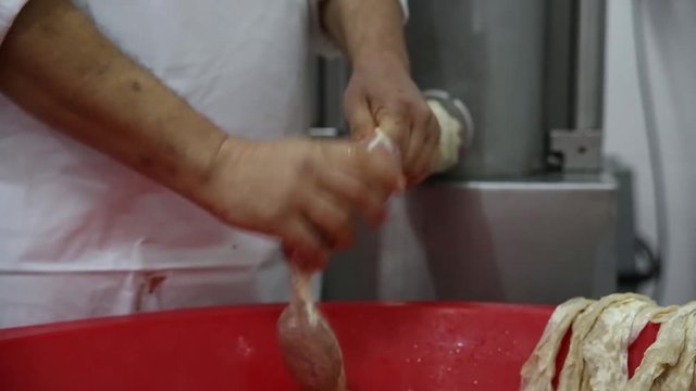 Butcher making sausages , sucuk