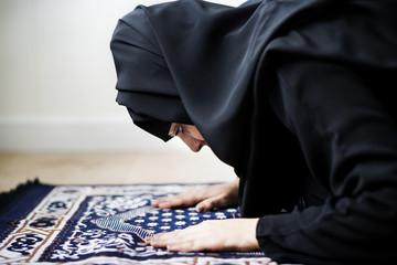 Muslim woman praying in Sujud posture - obrazy, fototapety, plakaty
