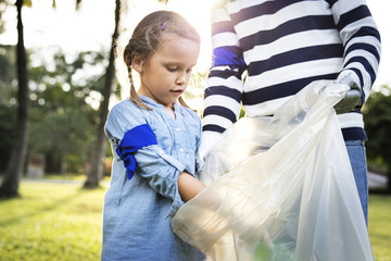 Kids picking up trash in the park