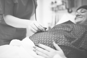 A trimester pregnant woman getting a checkup