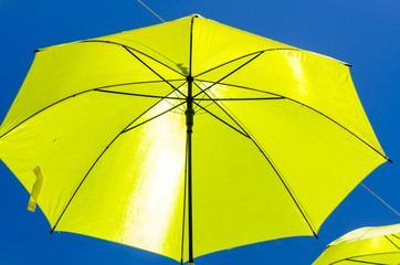 Colourful umbrellas urban street decoration. Hanging colorful umbrellas over blue sky, tourist attraction