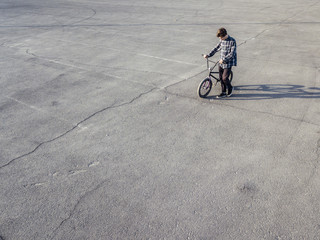 copy space young boy with bike on asphalt background isolated