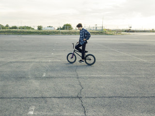 young street urban rider on the bmx bike in the street aerial view