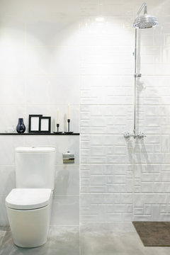 Modern bathroom interior with modern countertop basin, toilet and mirror