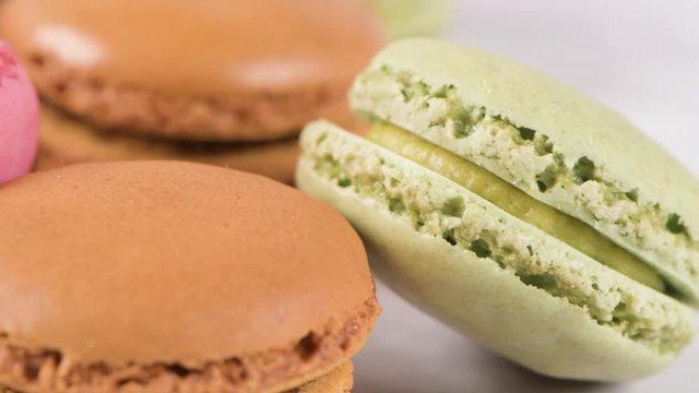 Macarons macaroons cookies dessert from France isolated on a white marble countertop.