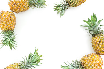 Frame of pineapple fruits on white background. Flat lay, top view. Food concept with copy space