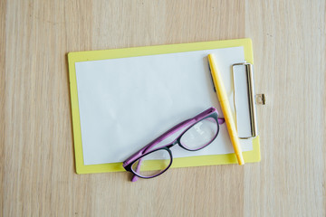 notebook office desk and mobile on wood table background