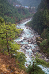 Beautiful river and mountains landscape in forest during trekking route to the Everest Base Camp