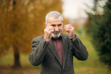 Grandpa with a big well-groomed beard wearing a glasses