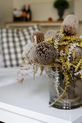 dried yellow Banksia flowers in vase