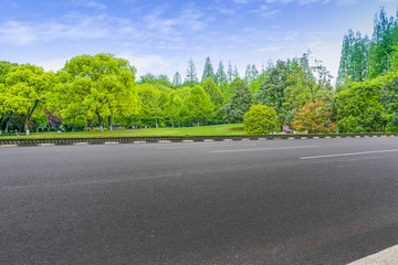 Asphalt road square and river hill under the blue sky